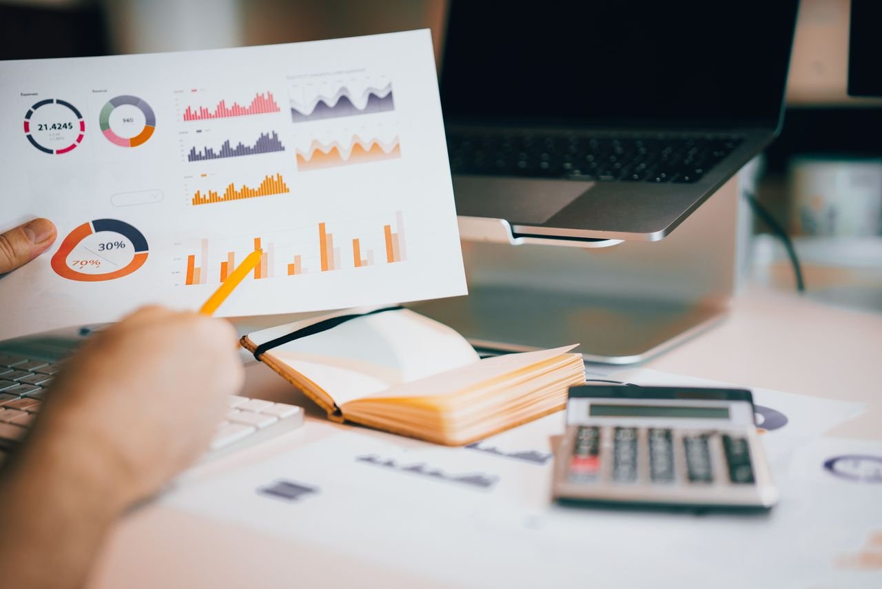Analyst reviewing charts and financial data to apply discounts for lack of marketability and control
