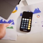 Business analytics desk with graphs and laptop for comparing fair market value and fair value