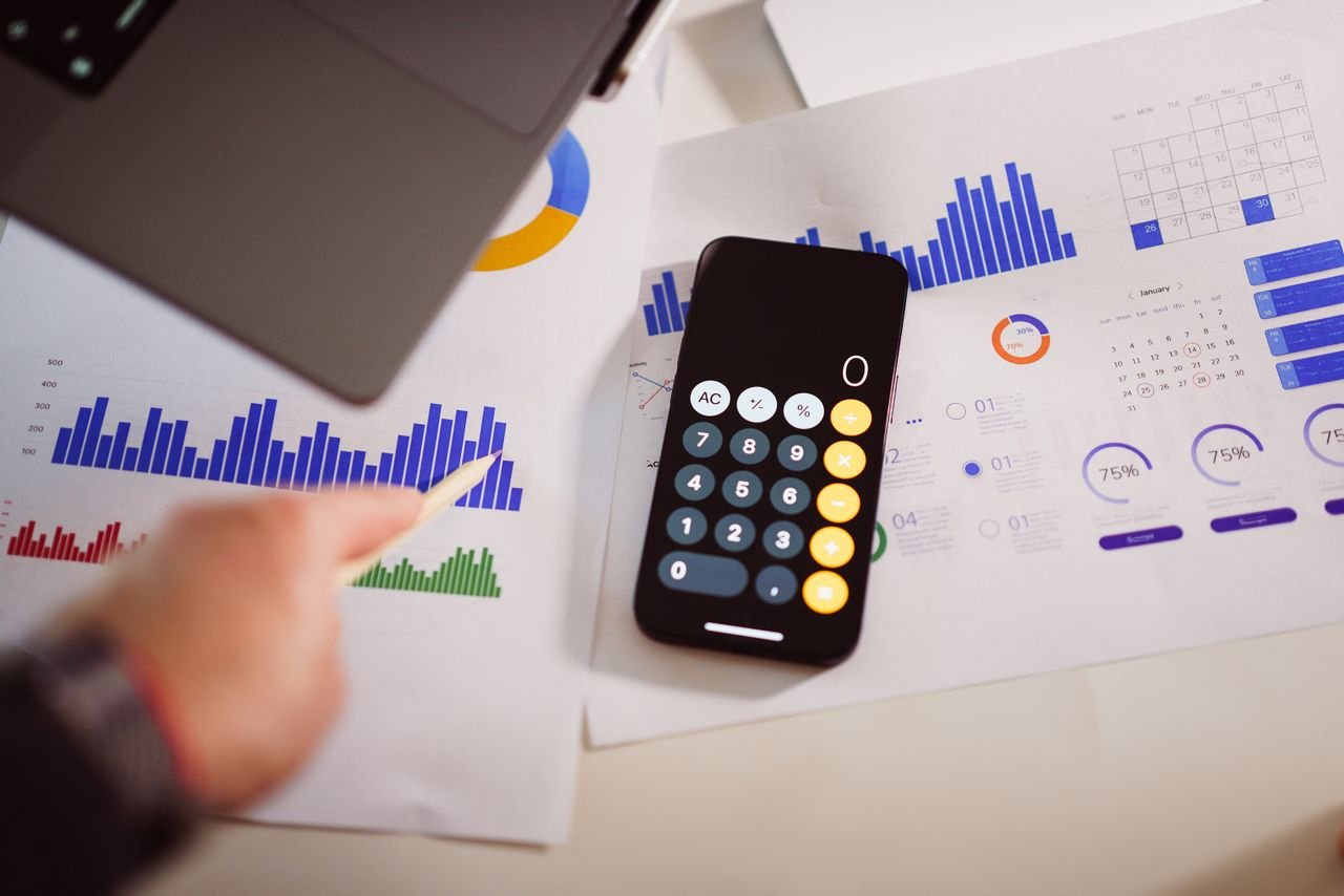 Business analytics desk with graphs and laptop for comparing fair market value and fair value