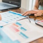 Financial graphs and a calculator on a desk during a business valuation for a Chapter 11 restructuring