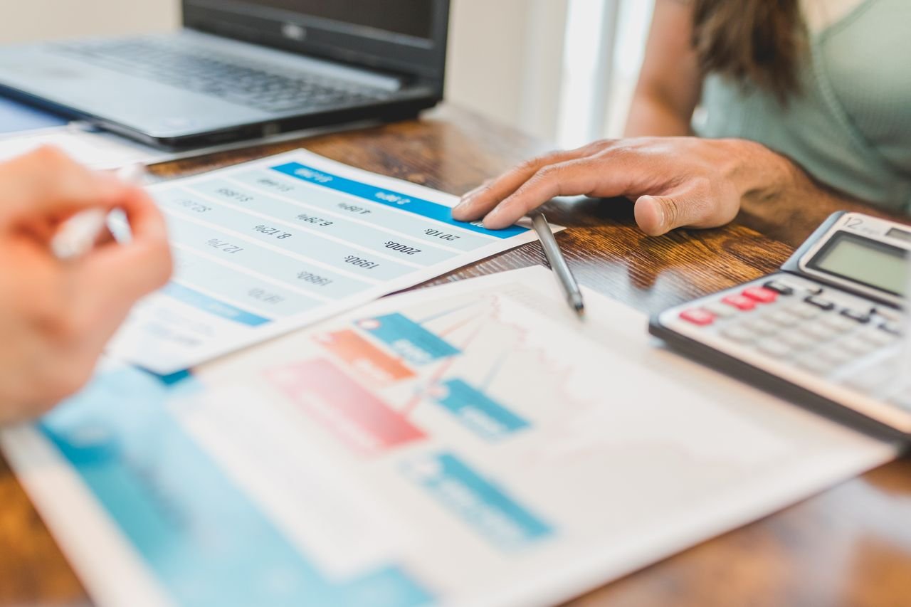 Financial graphs and a calculator on a desk during a business valuation for a Chapter 11 restructuring